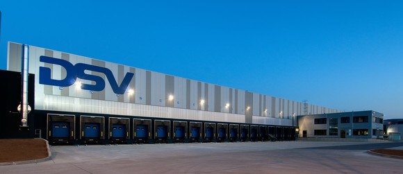 An industrial distribution property in Europe, with the letters DSV on the side of the building.