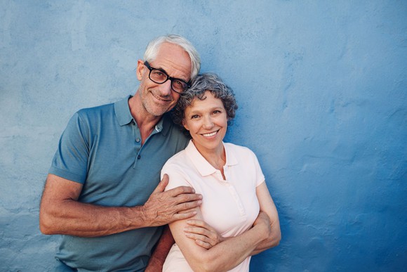 Mature man and woman hugging and smiling