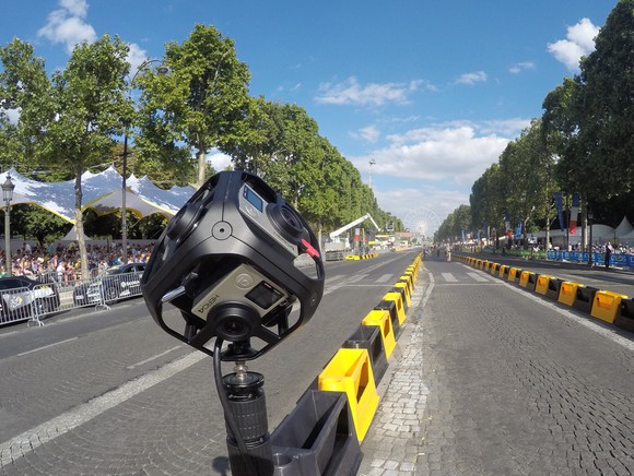 GoPro camera mounted on a barrier at a road race.