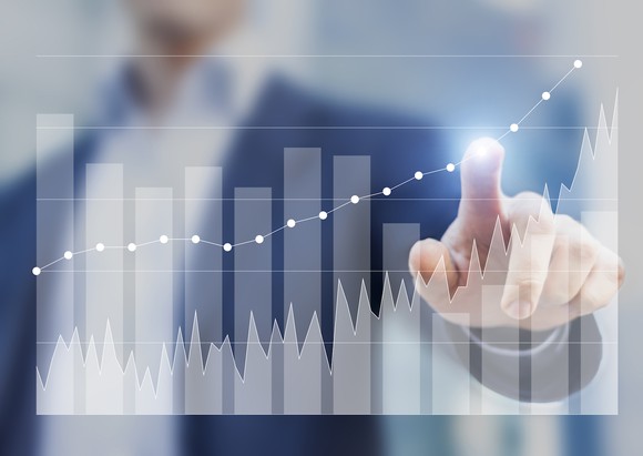 Man touching a bar chart with his index finger.