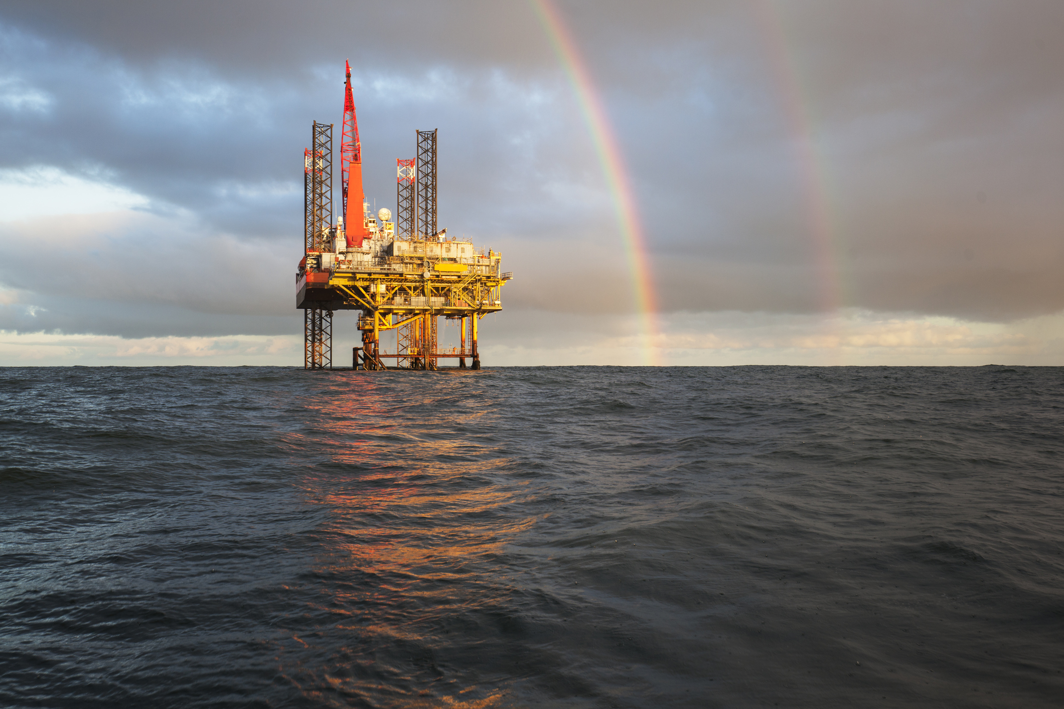 An Offshore Jack Up Rig with a rainbow.