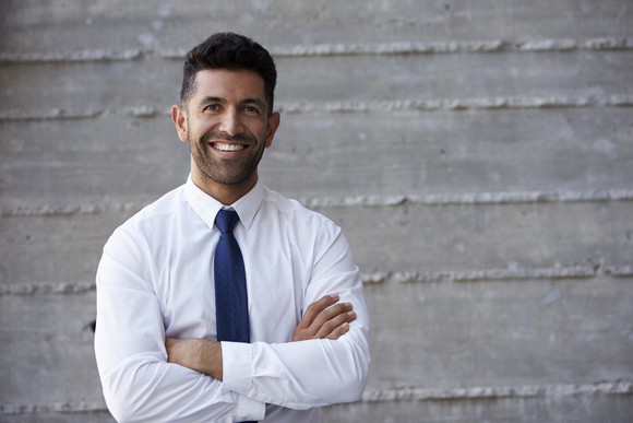 Smiling man in collared shirt and tie