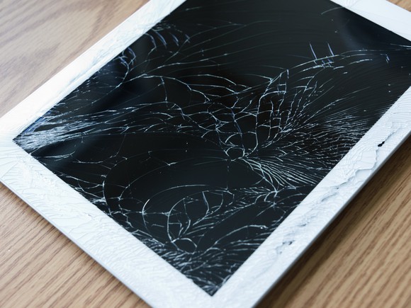 A tablet computer with a shattered screen.