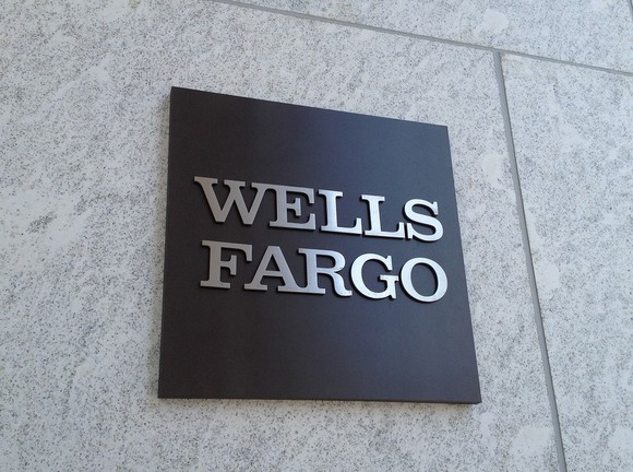A Wells Fargo sign affixed to a marble wall.