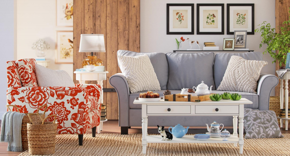A Wayfair-advertised living room including a chair, couch, coffee table, lamp, and pictures on the wall.