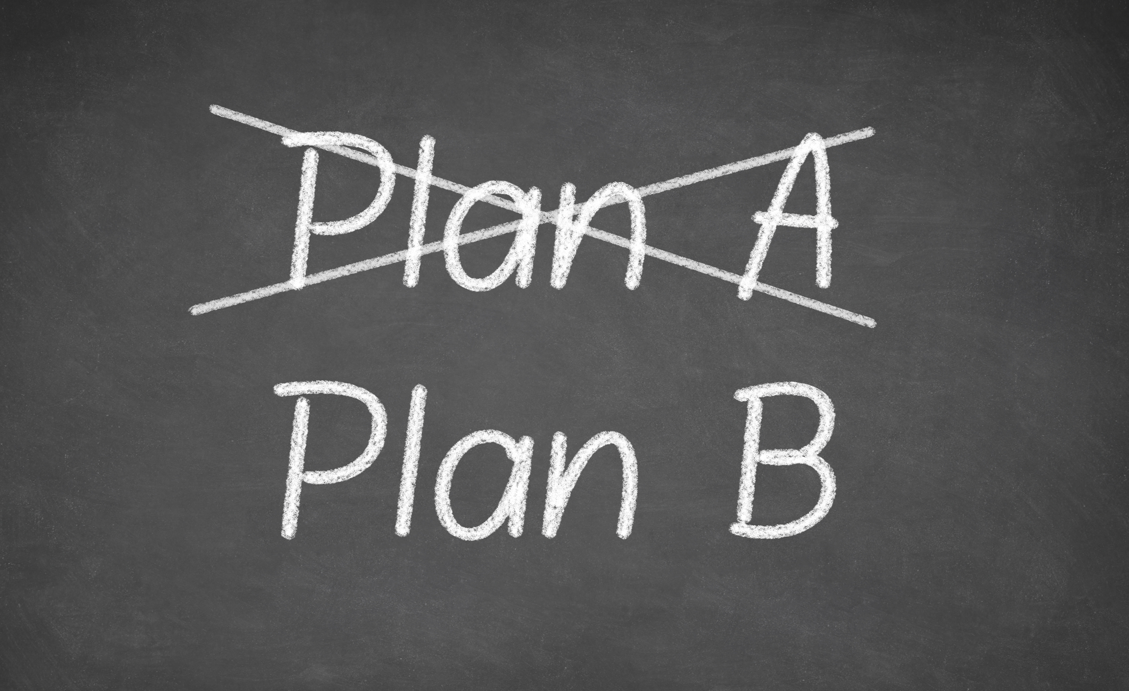 Crossing out Plan A and writing Plan B on chalkboard