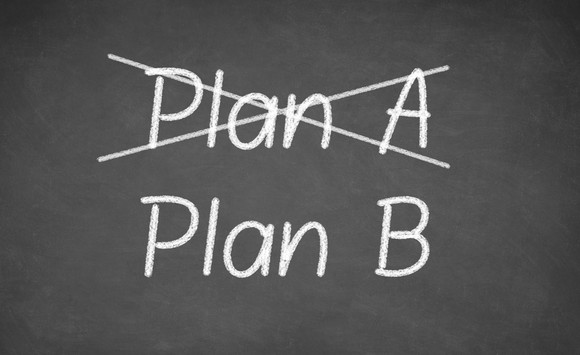 Crossing out Plan A and writing Plan B on chalkboard