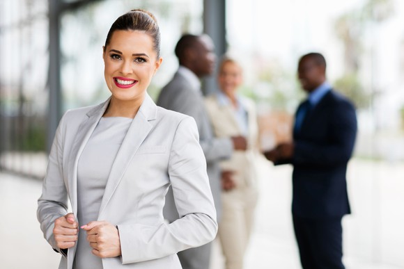 Smiling female in business suit wearing lipstick