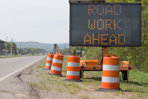 Road work ahead sign on the side of the road.