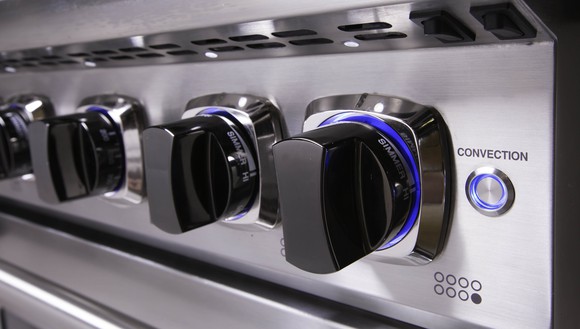 Knobs on the front of a stove.