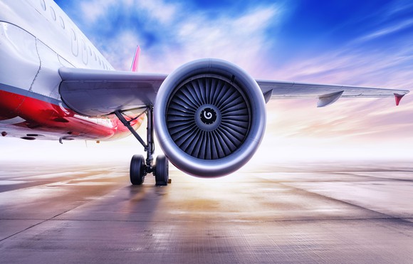 A jet engine is featured, part of a plane sitting on the tarmac.
