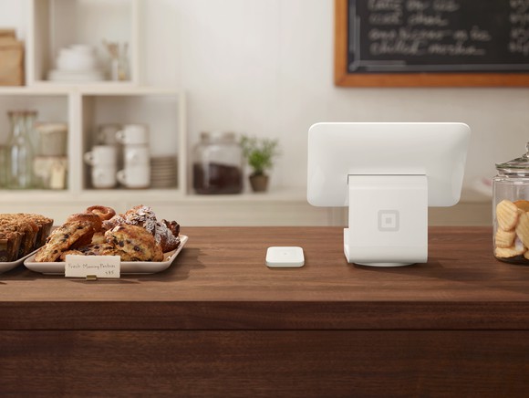 A Square payment terminal on the counter of a bakery.