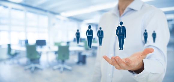 Graphic of a man holding graphics of people.