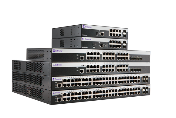 A stack of 6 Extreme Networks routers and switches.