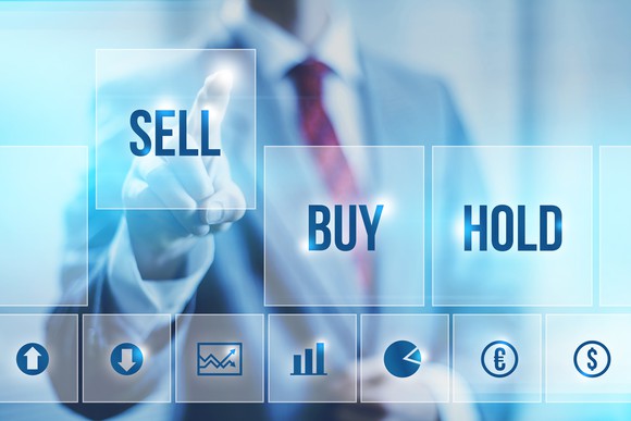Man clicking "Sell" button instead of "Buy" or "Hold"
