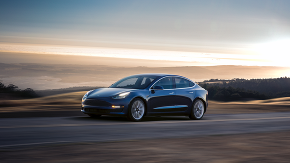 A blue Model 3 driving