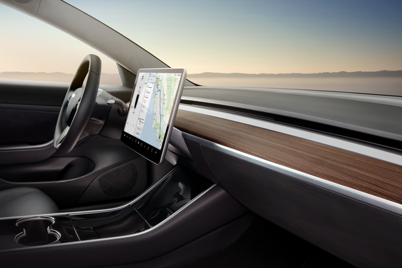 Model 3 interior, highlighting the vehicle's 15-inch touch display and its minimalistic design.