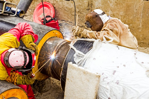 A team of welders working on a pipeline.