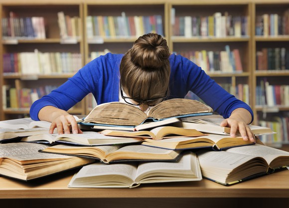 Student Studying Hard Exam and Sleeping on Books
