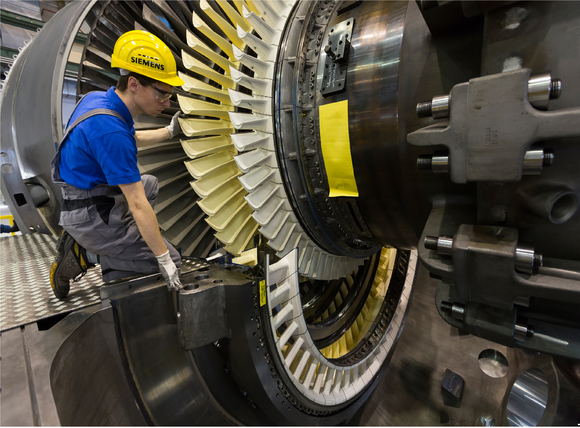 a Siemens technician fitting a gas turbine