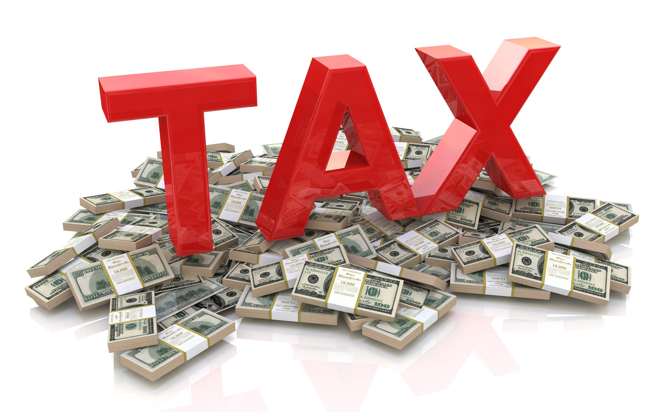 Big red letters spelling tax sit atop a pile of money.