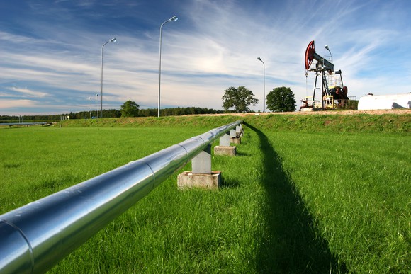 A pipeline coming from an oil pumpjack.