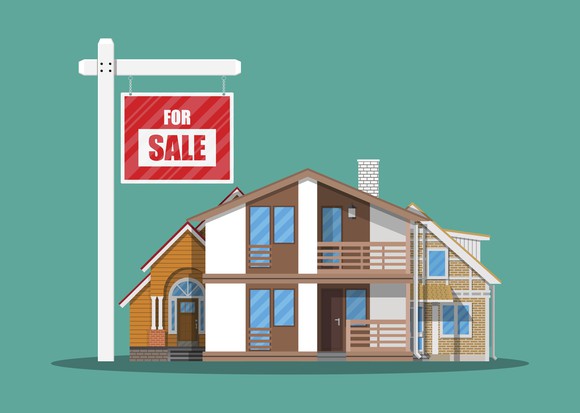 For sale sign in front of house