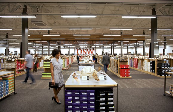DSW shoe store interior with several shoppers browsing