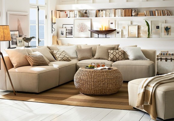 Nicely decorated room with beige and tan colors by Pottery Barn