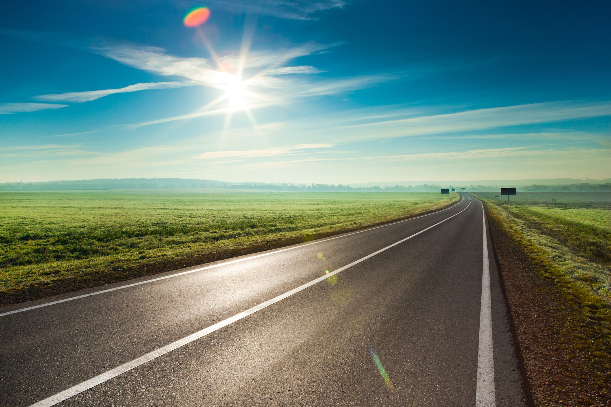 A long road stretches out into the distance.