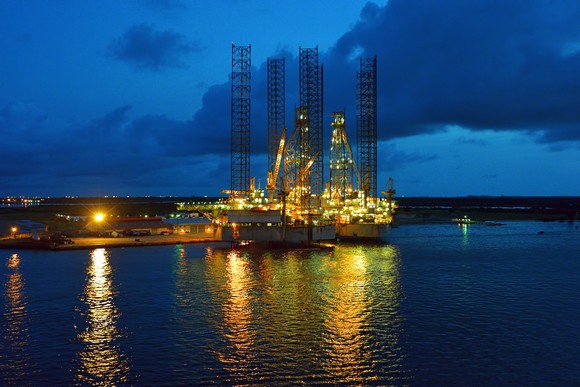 Offshore oil rig in dock at night