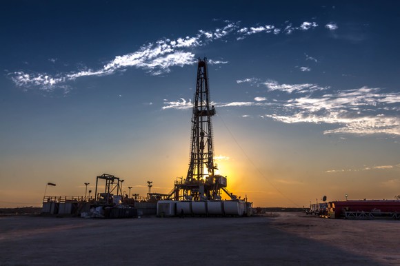 Land drilling rig in front of a sunset