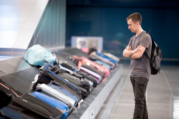 A man waiting for his bags at the airport.