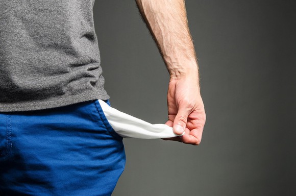 Man holding out empty pocket.