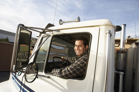 A man drives a truck.