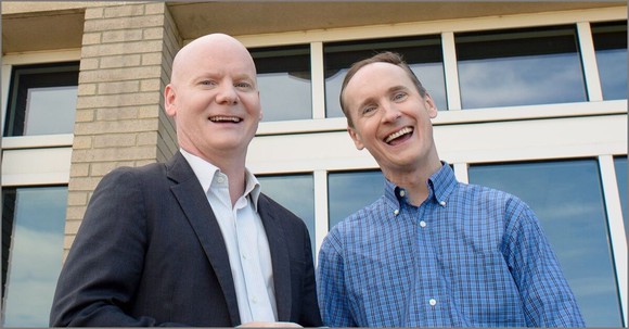 Tom and David Gardner smiling at the camera.