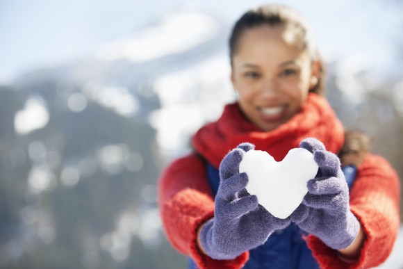 Woman with heart made of snow