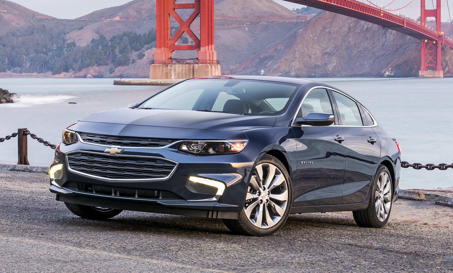 A 2017 Chevrolet Malibu sedan, parked near the Golden Gate Bridge in San Francisco.