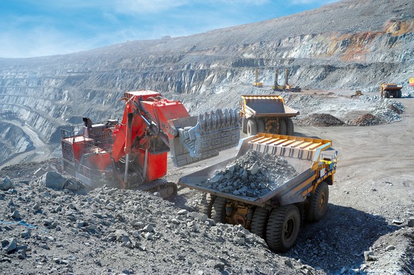 Loading of iron ore on to a very big dump truck.