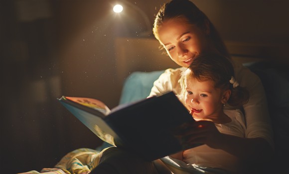 A woman reads to a child.