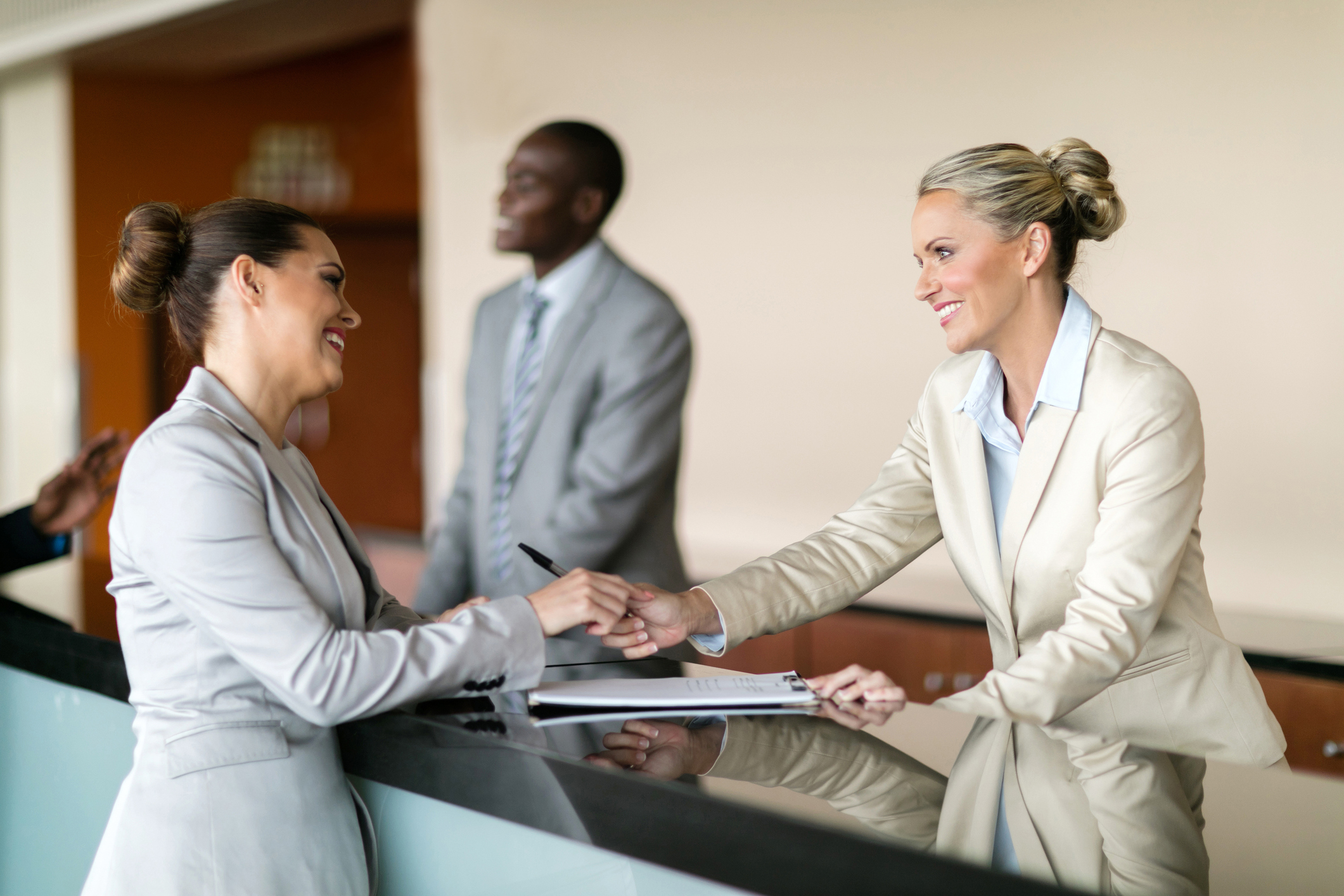 A woman checking in at a hotel reception desk