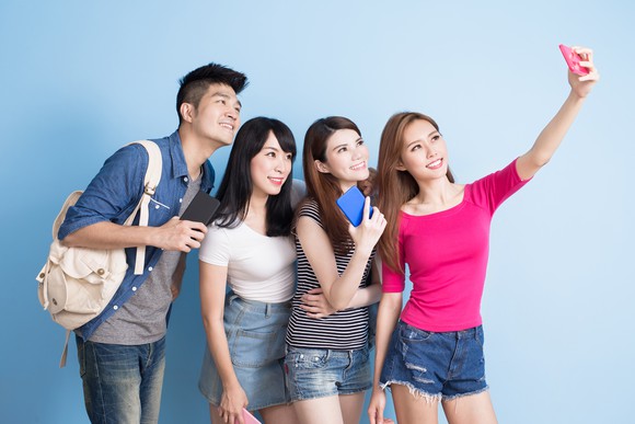 A group of young people take a selfie.