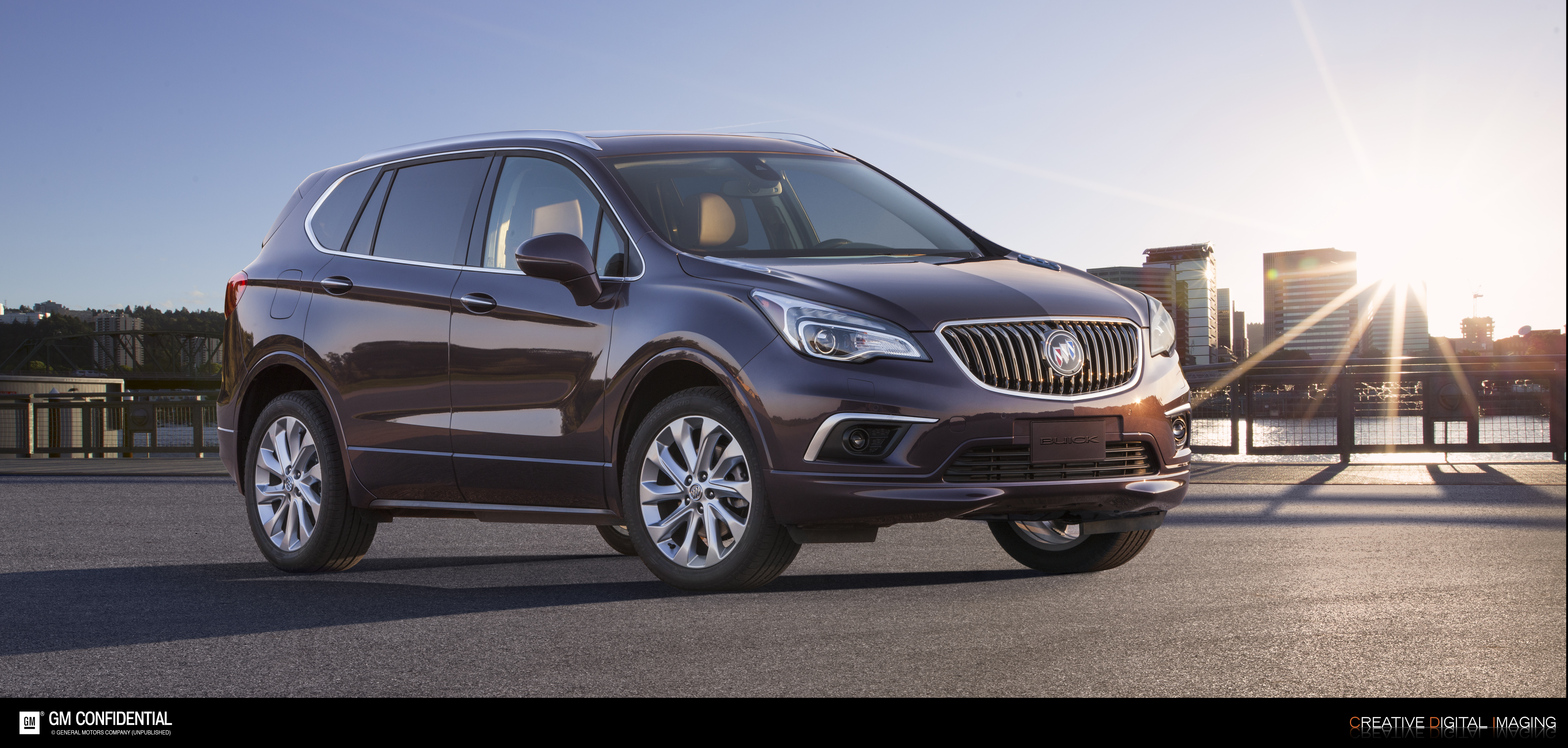 A 2017 Buick Envision with a skyline and sunset in the background.
