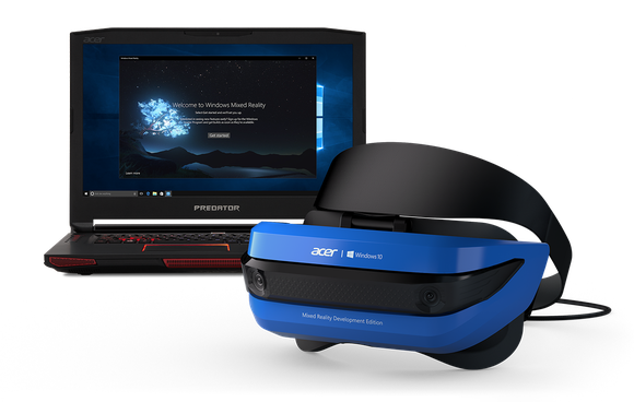 Virtual reality headset sitting next to computer.