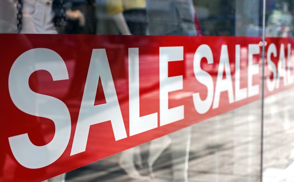 Sale sign in retail store window.