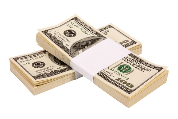 Two straps of $100 bills, one laid across the other.