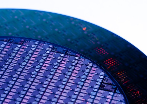 Semiconductor wafer circuit; detail of round wafer circuit in purple tones.