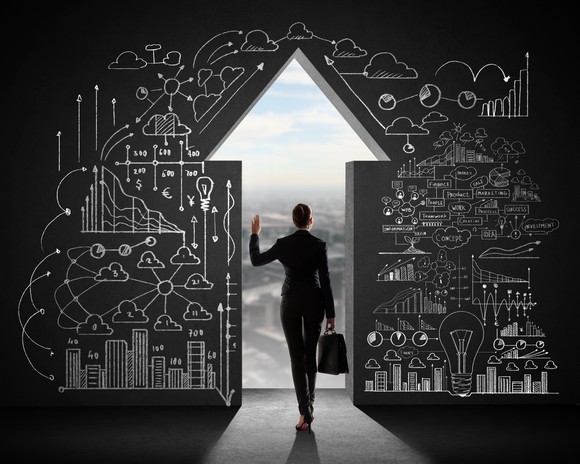 A businesswoman walking through a door shaped as an arrow facing up.