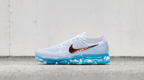 Nike Air VaporMax running show in white with translucent blue colored sole.