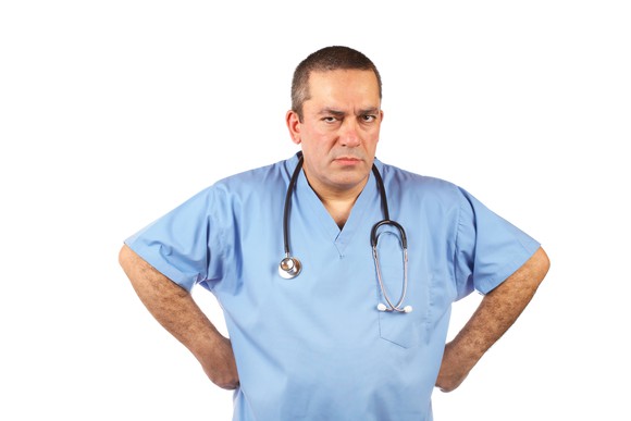 An angry doctor with his hands on his hips.